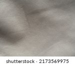 Small photo of White non-woven fabric as a background texture. Abstract background with texture of white perforated spunbond spunlace synthetic fiber nonwoven fabric.