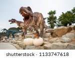 Big Brown Dinosaur Statue On...