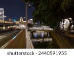 Small photo of Guangzhou, Canton, China, 03 01 2024 : Night view of the Lizhiwan or Liwan Canal in Guangzhou, Canton, China. Illuminated old stone bridges. Banyan or banian trees on the banks. Buildings.