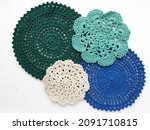 Flat lay multicolored crochet doilies pattern on white background