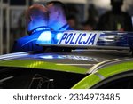 Small photo of 06.30.2023 wroclaw, poland, Polish police car with blue flashing beacon on the roof of the police car. Alarm in the evening