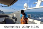 Small photo of Phuket, Thailand, 30,September, 2023: Stewardess on a yacht and a boy, boy kisses a stewardess on a yacht, yachting team and guests