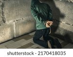 Small photo of an unrecognizable man is captured in the basement bound by a rope hand