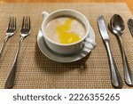 Small photo of a white bowl with hot herculean porridge on the table