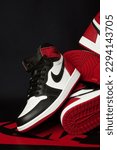 Small photo of Tangerang, Indonesia - April 27, 2023: Nike Air Jordan 1 Retro High Black Toe, red, black and white color on black background