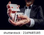 Small photo of Croupier or casino dealer at gambling club or casino. Close up of male hand. Gambling concept.