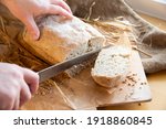 Woman Slices Fresh Bread. Hands ...