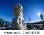 Small photo of St. Augustine, FL, USA – December 30 2023: Regal Guardian: Fisheye View of the Lion Statue at the Entrance to St. Augustine's Bridge of Lions