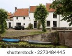 White houses with red roof tiles along the old harbor in the picturesque Dutch fortified town of Naarden.
