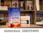 Small photo of Setif, Algeria - April 04, 2023: Close up The English Journalist Jojo Moyes's The Giver of Stars novel in the bookshop.