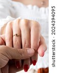 Small photo of She said yes concept, Solitaire ring on woman's hand held by her fiance. Man holding woman's hand with ring close up, women jewelry shot idea photo.