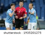 Small photo of ROME, Italy - 12.03.2021: Patric (LAZIO), REFEREE RAPUANO, Lucas Leiva (LAZIO) in action during the Italian Serie A league 2021 soccer match between SS LAZIO VS CROTONE at Olympic stadium in Rome.