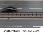 Motion blur of the car on the four lane road. Transportation background photo.