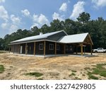 Post frame pole barn construction with metal siding and metal roofing, concrete flooring, heavy beams, bardominimum