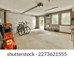Small photo of Amsterdam, Netherlands - 10 April, 2021: a garage with two bikes parked in front of the garage door and an electric heater hanging on the wall