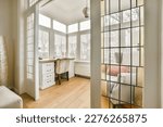 Small photo of a living room with wood flooring and white shutters on the windows looking out onto an area with wooden floors