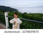 Small photo of PHETCHABUN, THAILAND – OCTOBER 15, 2023: A little Asian girl standing on the morning at the view point of Khao Kho กistrict in Phetchabun province of Thailand.Activity base learning on the holiday.