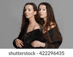 Small photo of young fashion twins. sister embosom her sister. perfect healthy skin. red lips.