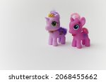Two little cartoon unicorn toys