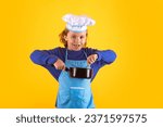 Small photo of Kid chef cook with cooking pot stockpot. Cooking, culinary and kids. Little boy in chefs hat and apron on studio isolated background.