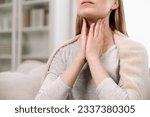 Small photo of Cropped view of woman hands touching lymph nodes on throat. Self-examination and palpation thyroid glands. Having pain or scratchy sensation