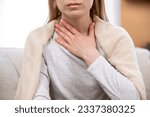 Small photo of Close up view of female hand on neck, suffering from sore throat. Cropped view of sick woman feel discomfort in chest, painful, difficult to swallow. Concept of tonsillitis, angina, pectoris