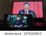 Small photo of Kyiv, Ukraine - March 16 2023: Chinese president Xi Jinping on the phone screen and Volodymyr Zelenskyy the president of Ukraine in the background.