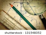 Small photo of magnifying glass and a slide rule on the old page with the calculations in mechanics