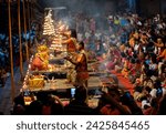 Small photo of Varanasi or Benarras, Uttar Pradesh, India - 18 March 2019: Ganga aarti ceremony rituals performed by Indian Hindu priests on the banks of river ganges at Dashashwamedh Ghat(ghats) on an evening.