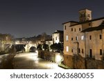 Small photo of The night view of Basilica of St. Bartholomew on the Tiber Island and Pons Aemilius (Italian: Ponte Emilio), today called Ponte Rotto, the oldest Roman stone bridge in Rome, Italy.