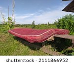 Small photo of Indonesian people call it kapok mattress. Red and white sleeping mattrees are dried in the sun to soften the texture again