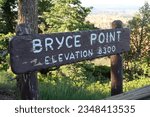 Small photo of Brown and white wood sign for Bryce Point. Elevation 8300 feet. Overlook point for Bryce Canyon National Park Amphitheater