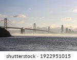 Bay Bridge span into the city San Francisco with fog rolling underneath 