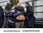 Small photo of Moscow, Russia - 25 November 2021, People came to court to liquidate organization Human Rights Center MEMORIAL. People hug in support of each other. One of them has a bag with symbols of the Memorial
