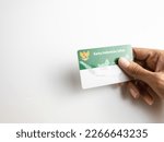 Small photo of Holding a Healthy Indonesia Card (Health Insurance card from the Government of Indonesia) under the auspices of BPJS. selected focus