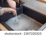 Overflowing kitchen sink, clogged drain, plumbing problems, trying to unclog