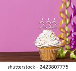 Small photo of Birthday Cake With Candle Number 232 - On Pink Background.