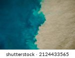 Aerial view of mixing blue and dirty ocean water. Natural abstract background
