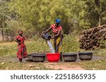 Small photo of Abaji, FCT Abuja - January 20, 2023: African Women Fetching Water From an Open Hand Dug Well in a Rural Community.