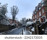 Small photo of London, UK - 12.12.2022.Windmill Hill street view, Hampstead, London. Winter in London, snow, snowing. Hampstead is an affluent residential area favoured by academics, artists and media figures