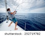 Young Man Fishing In Open Sea...