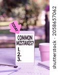 Small photo of Text sign showing Common Mistakes Question. Word for repeat act or judgement misguided making something wrong Abstract Outdoor Smartphone Photography, Displaying New Device