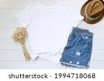Blank white t shirt. Flat lay, top view travel fashion boho style look with woman clothes and accessories