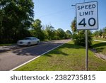 A car drives past the 40 mph speed limit sign on a country road in Florida - USA