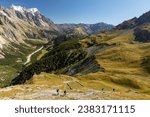 Small photo of Aosta Valley, Italy - 23.08.2022: Hikers on a clockwise walk in Italy around Mont Blanc
