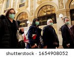 Small photo of MILANO,ITALY- FEBRUARY 22, 2020: Coronavirus in Italy.Protective mask.Tourists in face masks at the Wiktor Emanuel II Gallery