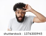 Omg unbelievable. Portrait of impressed and surprised handsome adult african american bearded guy taking off glasses cannot believe own eyes dropping jaw and bending towards camera amazed