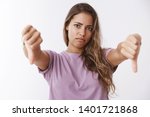 Girl reacting awful bad idea, showing thumbs down grimacing disapproval, disagree disliking stupid inappropriate behaviour looking judgemental unimpressed upset and disappointed, white background