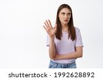 Small photo of Stop talking. Blah blah so annoying. Young arrogant woman roll her eyes and raising hand to block, refusing to listen, thats enough, bored with conversation, white background