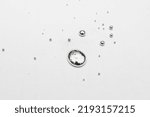 Small photo of drops of metallic liquid mercury